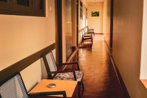 a row of chairs and tables in a hallway at Sunny Lanka Guest House in Matara