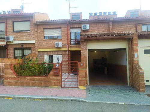 a brick building with a garage and a door at Habitacion Privada Triple Toledo in Toledo