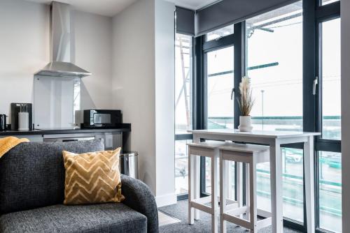 a living room with a couch and a table at K Suites - Colne House in Lowestoft