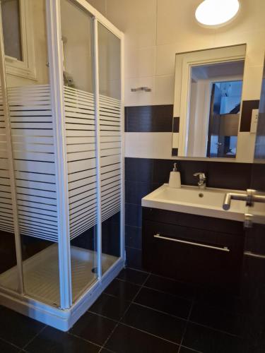 a bathroom with a shower and a sink at Kalifi Pool Apartment in Paralimni