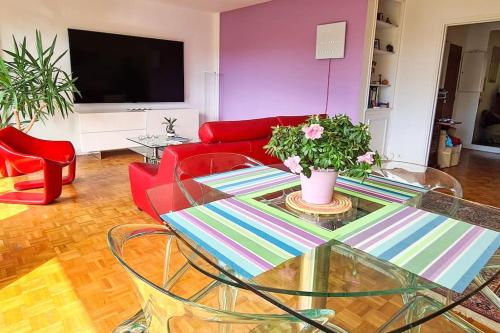 un salon avec un canapé rouge et une table en verre dans l'établissement 3 room apartment, 90 sqm, quiet, 25 min from Paris, à Le Vésinet