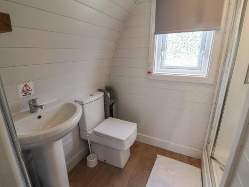 a bathroom with a toilet and a sink at Hare's Hollow in Skipton