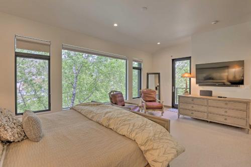 a bedroom with a large bed and a tv at Luxurious Home, Walk to Beaver Creek Gondola! in Avon