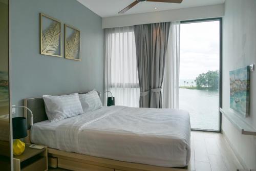 a bedroom with a bed and a large window at Cassia Residences 1 in Bang Tao Beach