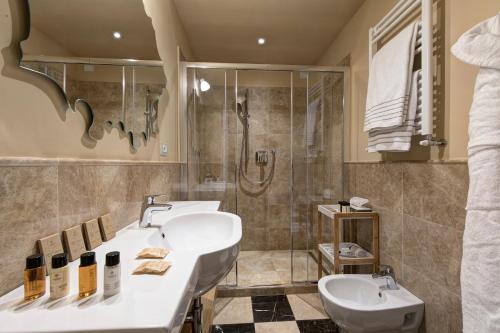 a bathroom with two sinks and a shower at Grand Hotel Cavour in Florence