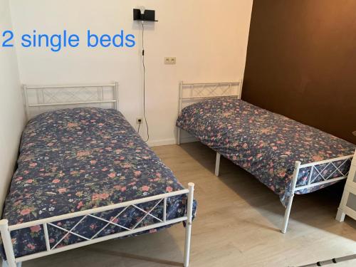 two beds in a room with two single beds at Cocon in Jumet
