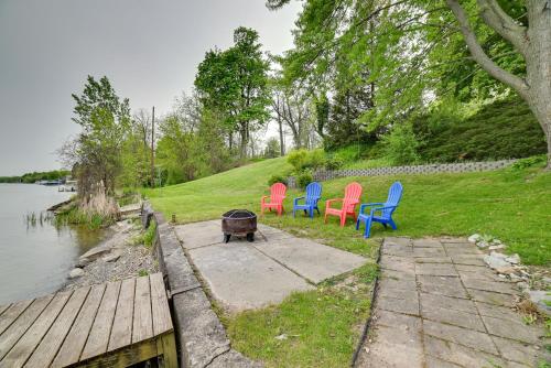a group of chairs sitting next to a body of water at Cayuga Lake Retreat in Seneca Falls with Dock! in Seneca Falls