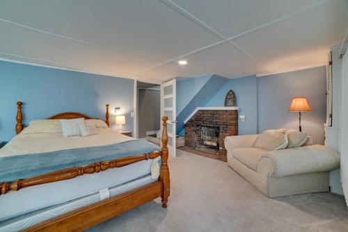 1 dormitorio con 1 cama, 1 silla y chimenea en Family-Friendly Cayuga Lake Retreat with Dock!, en Seneca Falls