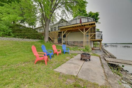 a group of chairs sitting on the grass next to a house at Cayuga Lake Retreat in Seneca Falls with Dock! in Seneca Falls