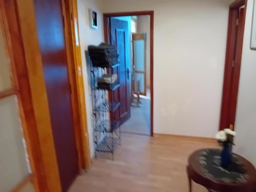 a hallway with a room with a door and a table at T3 N16 Ref 008 in Tavira