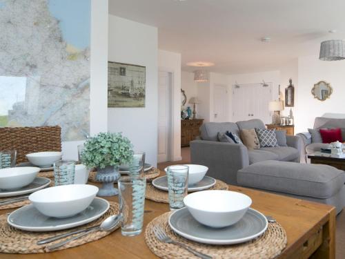 a living room with a table with bowls on it at Pass the Keys Beautiful 3 bedroom apartment with Pool Access in Trearddur