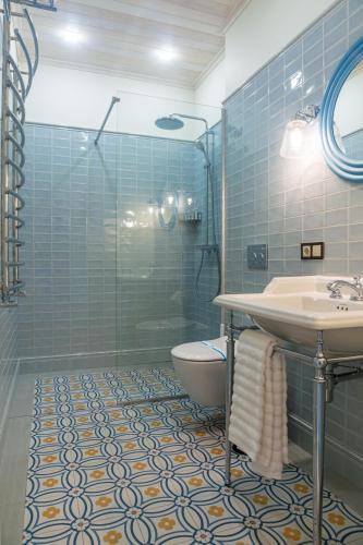 a bathroom with a sink and a toilet and a shower at WineGarden in Mukacheve