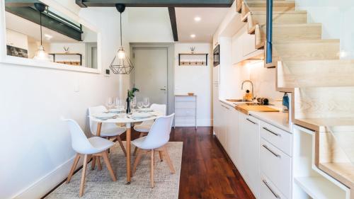 a kitchen and dining room with a table and chairs at Terrace Pool Apartment Oporto by LovelyStay in Porto