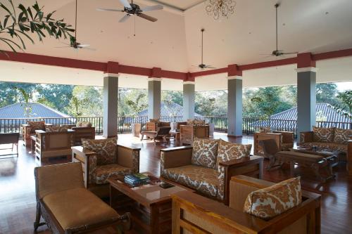 a large lobby with couches and tables and windows at Seerock The King's Domain in Sigiriya