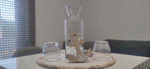 a table with a bottle and two glasses on it at FewoSaric Apartment Marlon in Vir