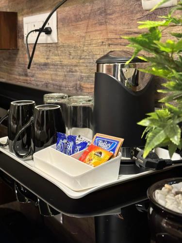 a tray of food on a counter with a coffee maker at ROYAL ACE LUXUR in Bangalore