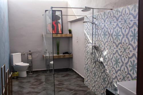 a bathroom with a glass shower and a toilet at R34 Boutique Guest House in Veliko Tŭrnovo