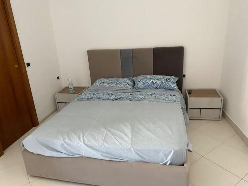 a large bed in a bedroom with two night stands at B&B La vecchia fornace in Teramo