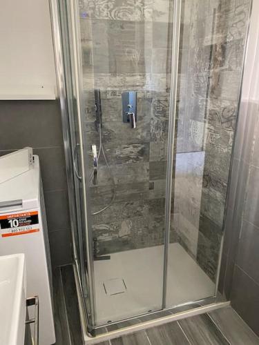 a shower with a glass door in a bathroom at B&B La vecchia fornace in Teramo