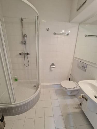een badkamer met een douche, een toilet en een wastafel bij Fantastic - Z6 Room - 504A in Warschau