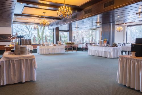 einen Bankettsaal mit Tischen und weißen Tischdecken in der Unterkunft Hotel Brücklwirt in Niklasdorf