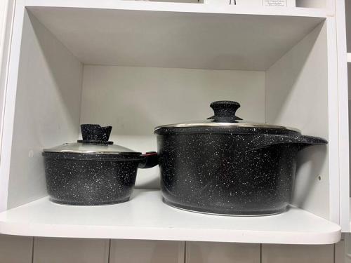 two pots sitting on a shelf in a refrigerator at 2-х комнатная квартира в центре in Almaty
