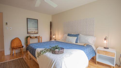 a bedroom with a blue bed with a basket on it at Chalet BIA - Cap au Sud in Trois-Lacs