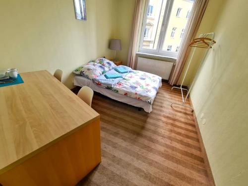 a small room with a bed and a table at Fantastic - Z6 Room - 702B in Warsaw