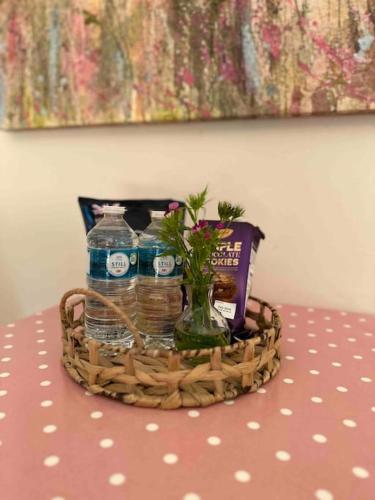 a basket with water and a book on a table at Leafy lodge in Lytham in Brown Moss Side