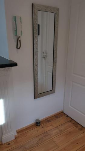 a mirror on a white wall with a wooden floor at Le Croisette center in Cannes