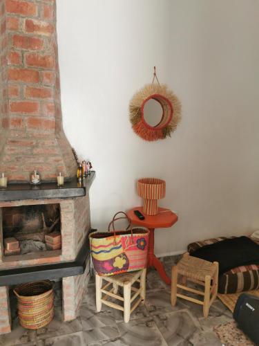 - un salon avec une cheminée, une table et une chaise dans l'établissement Chez Marie, à Al Ghar