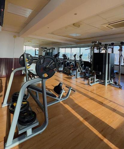 a gym with several treadmills and other equipment at Al Maha Int Hotel Oman in Muscat