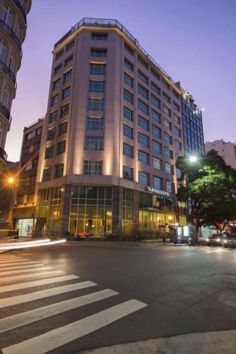 a large building on a city street at night at Eurobuilding Hotel Boutique Buenos Aires in Buenos Aires
