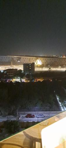 a view of a city at night with lights at pyramids grand museum inn in Cairo