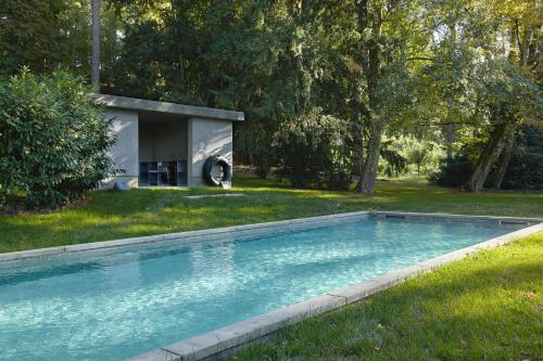 einen Pool in einem Hof mit einem Haus in der Unterkunft CHB - Château de la Haute Borde in Rilly-sur-Loire