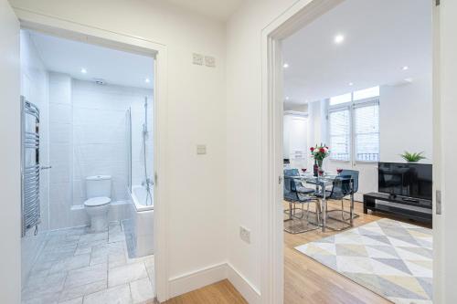 a bathroom with a shower and a toilet and a table at Turnmill Apartments in London
