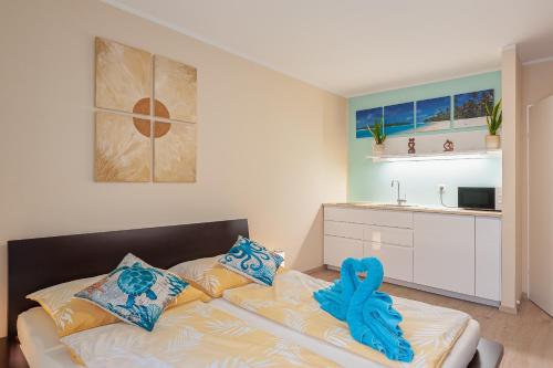 a bedroom with a bed with blue towels on it at Beach Design City Apartment Graz in Graz