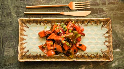 a plate of food with vegetables on a table at Baari The House of Fusion in Jaipur