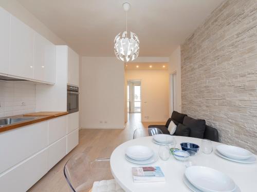 una cucina con tavolo bianco e piatti di Youhosty - Grazioli 4 a Milano