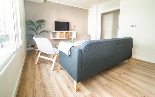 a living room with a couch and a table at Apartamento Plaza da Gándara in Narón