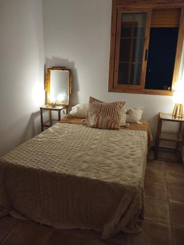 a bedroom with a large bed and a window at AMIRA home near Sitges in Sant Pere de Ribes