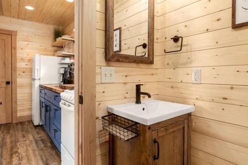 a bathroom with a sink in a wooden kitchen at One of a kind views of GNP - Cabin 2 in Polebridge