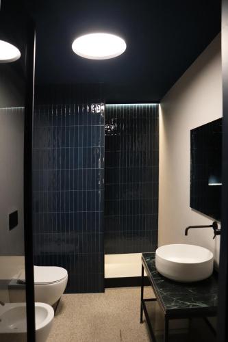 a bathroom with two toilets and a shower at Roiss Haus Suites in Lecce