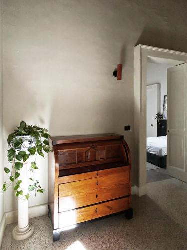 a bedroom with a wooden dresser next to a bed at Roiss Haus Suites in Lecce