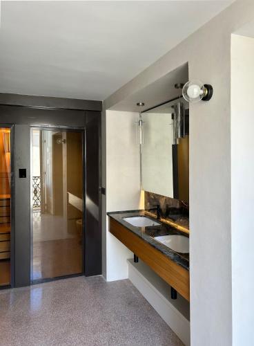 a bathroom with a sink and a mirror at Roiss Haus Suites in Lecce