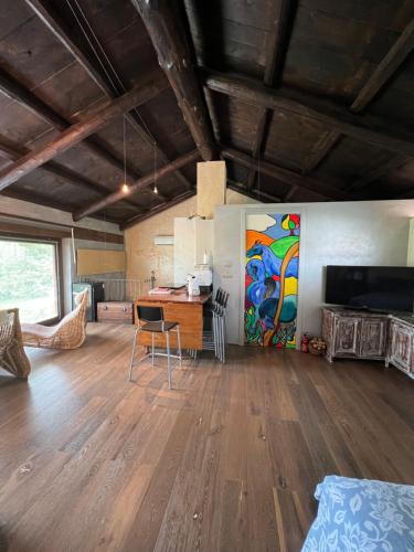 a room with a table and a painting on the wall at Casa del Bosco in Busca