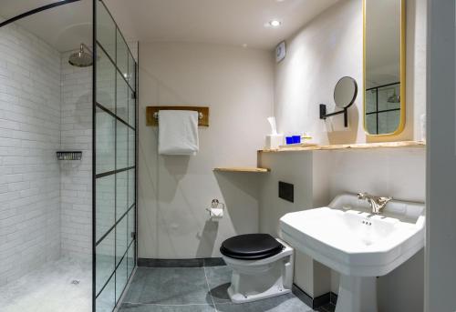 a bathroom with a sink and a toilet and a shower at The Cartford Inn in Great Eccleston