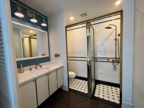 a bathroom with a shower and a sink and a toilet at Grand Florida Beach Waterpark Condo Resort in Na Jomtien