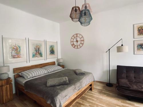 a bedroom with a bed and a clock on the wall at Atelier Lomani in Vienna