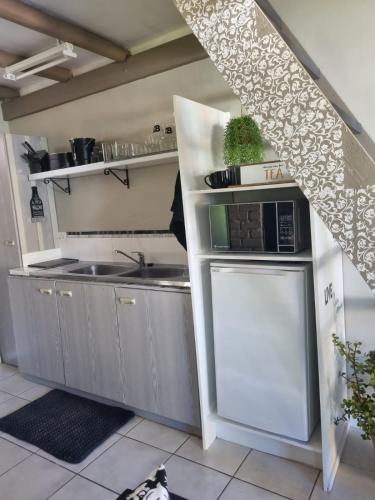 a kitchen with a sink and a stove at Angel 8 AirBnB Apartment 2 in Robertson